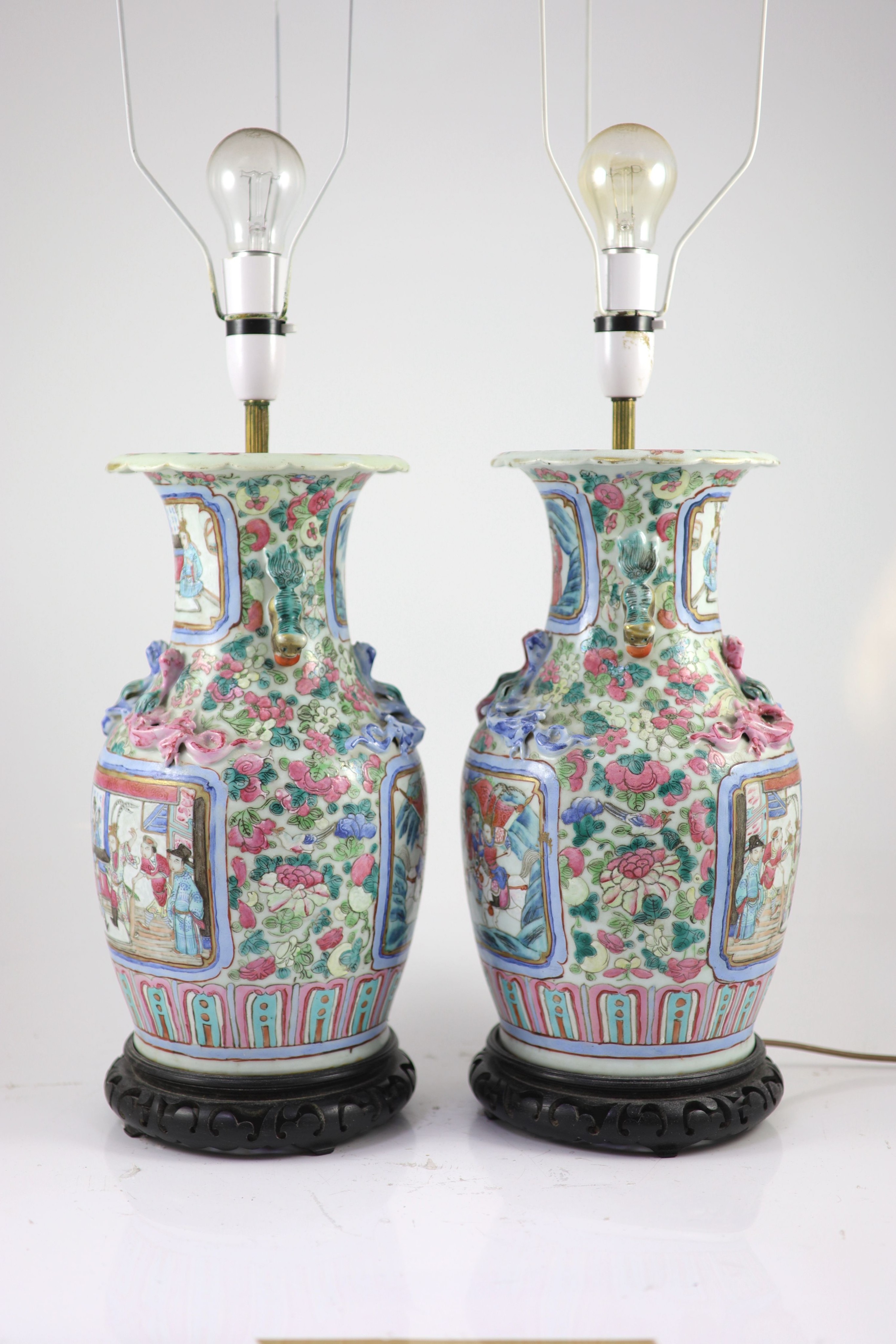 A pair of 19th century Chinese famille rose baluster vases, fitted as table lamps, on hardwood stands